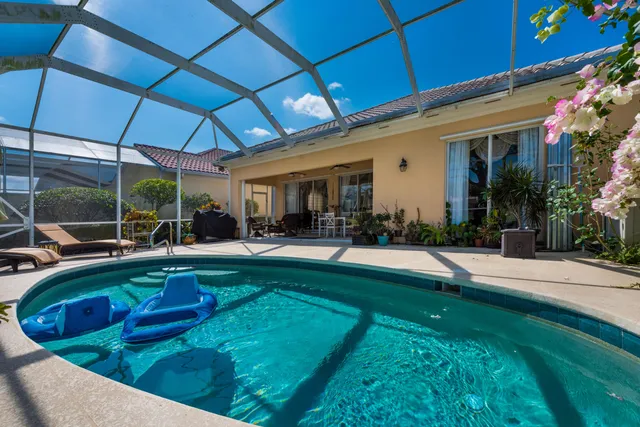 a view of swimming pool with outdoor seating and yard