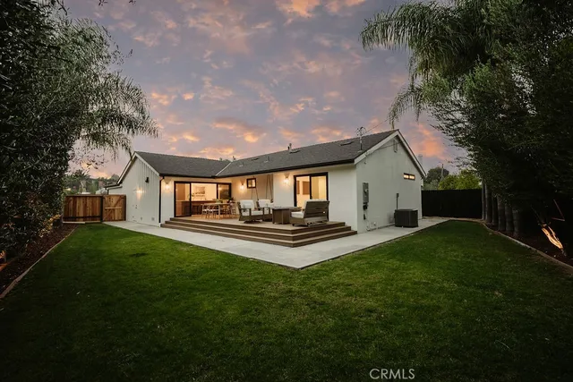 an aerial view of a house with a yard swimming pool and outdoor seating