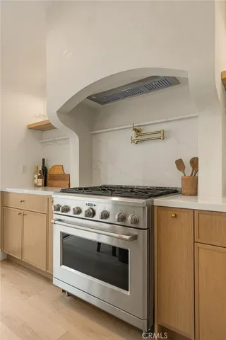 a white stove top oven sitting inside of a kitchen