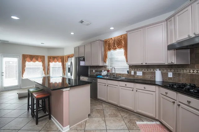 a kitchen with a sink stove and cabinets