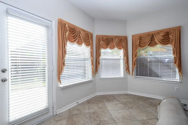 a view of an empty room and a window