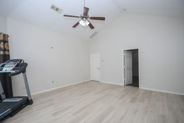 a view of room with hardwood floor and ceiling fan