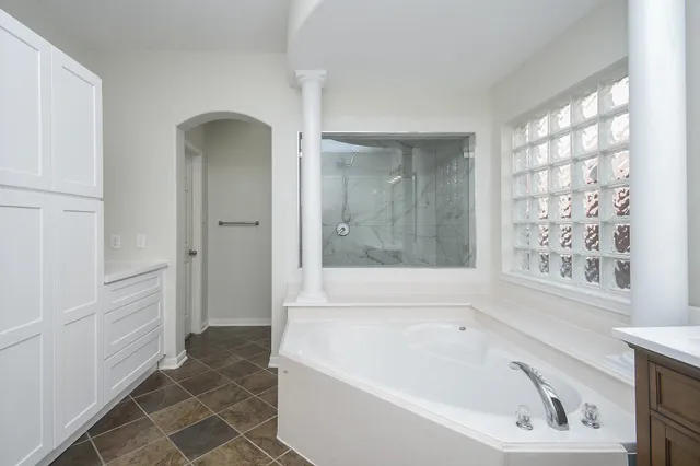 a bathroom with bathtub and shower