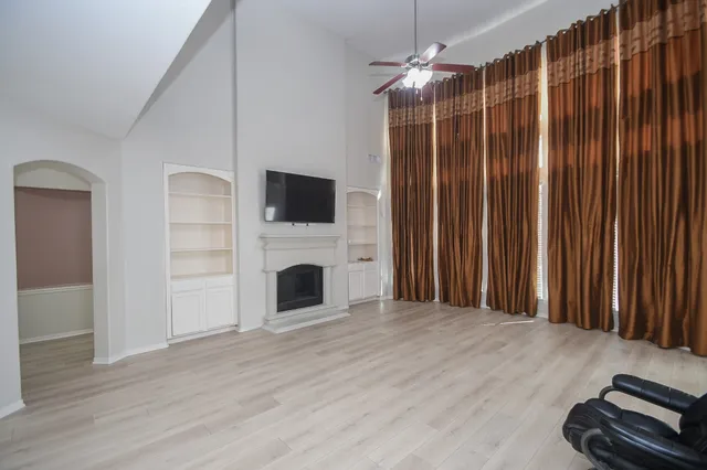 a view of a livingroom with a fireplace wooden floor and furniture
