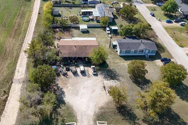 a view of a house with a yard and sitting area