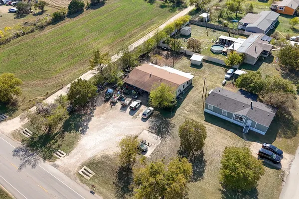 an aerial view of a house with a yard