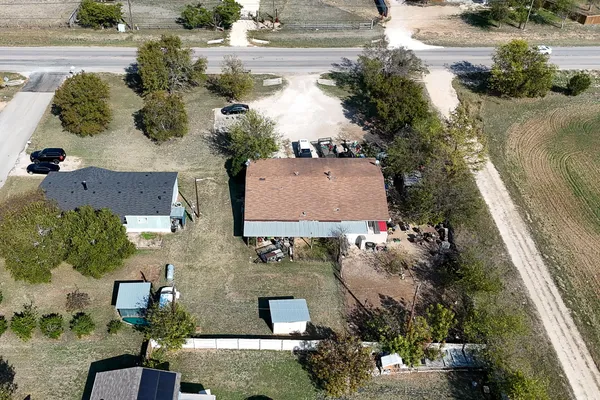an aerial view of residential houses with outdoor space