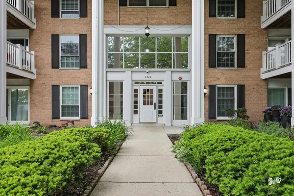 a front view of a building with a garden