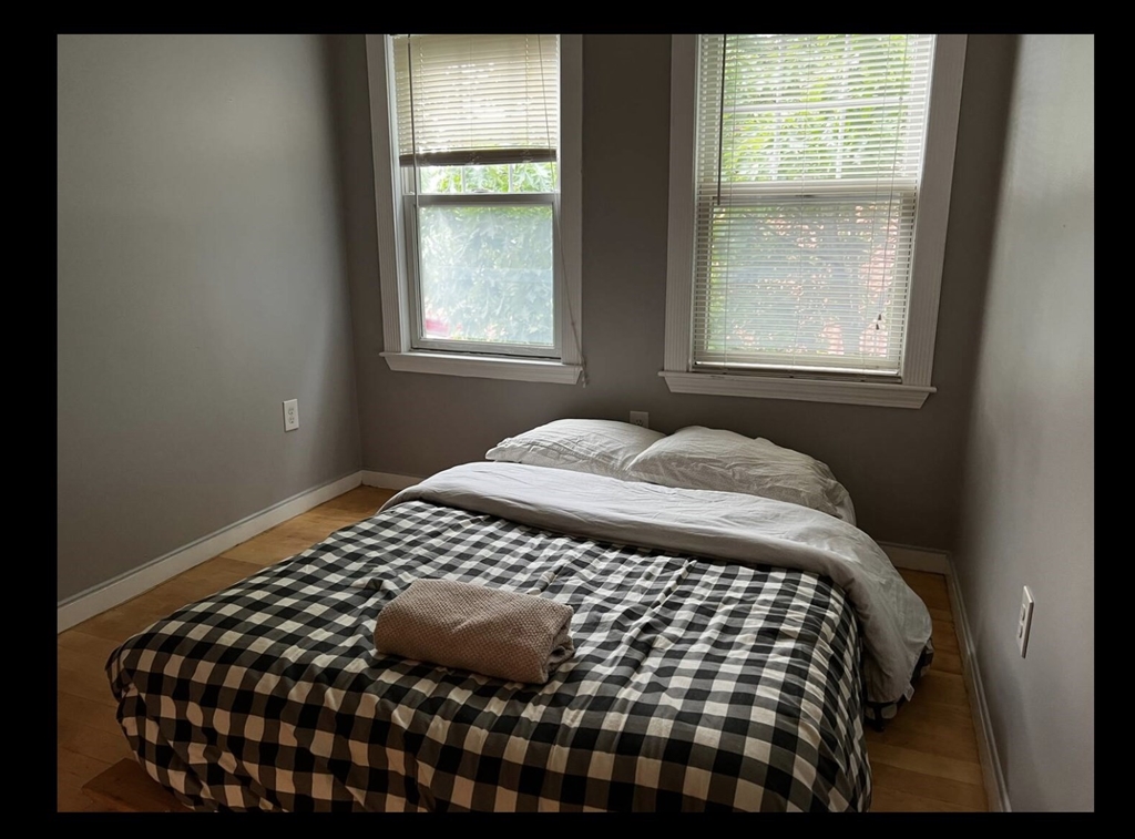 a bedroom with a bed and window