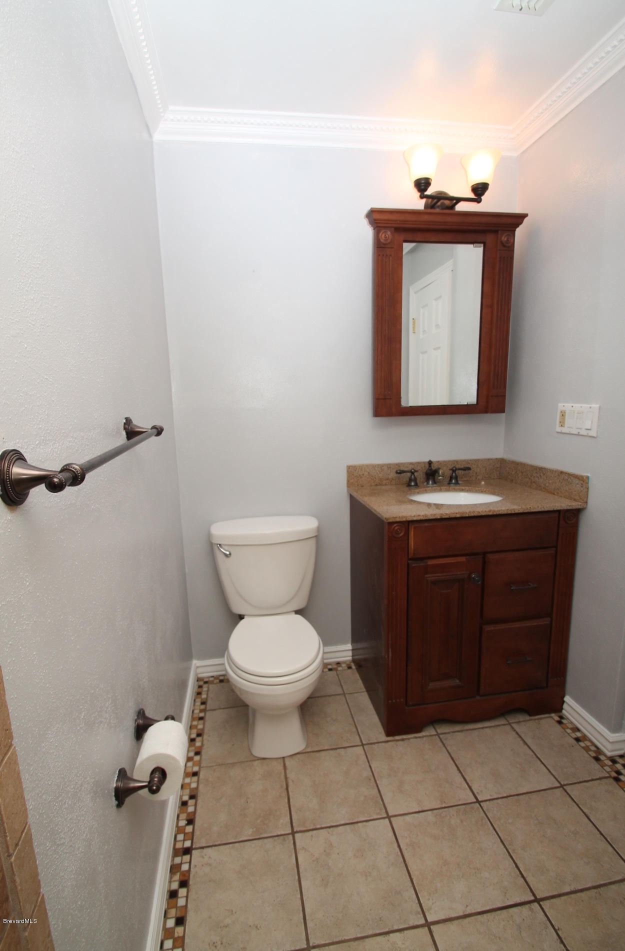 238 Capron Road Port St. John, FL 32927 - Photo 11 of 23 a bathroom with a toilet a sink and mirror