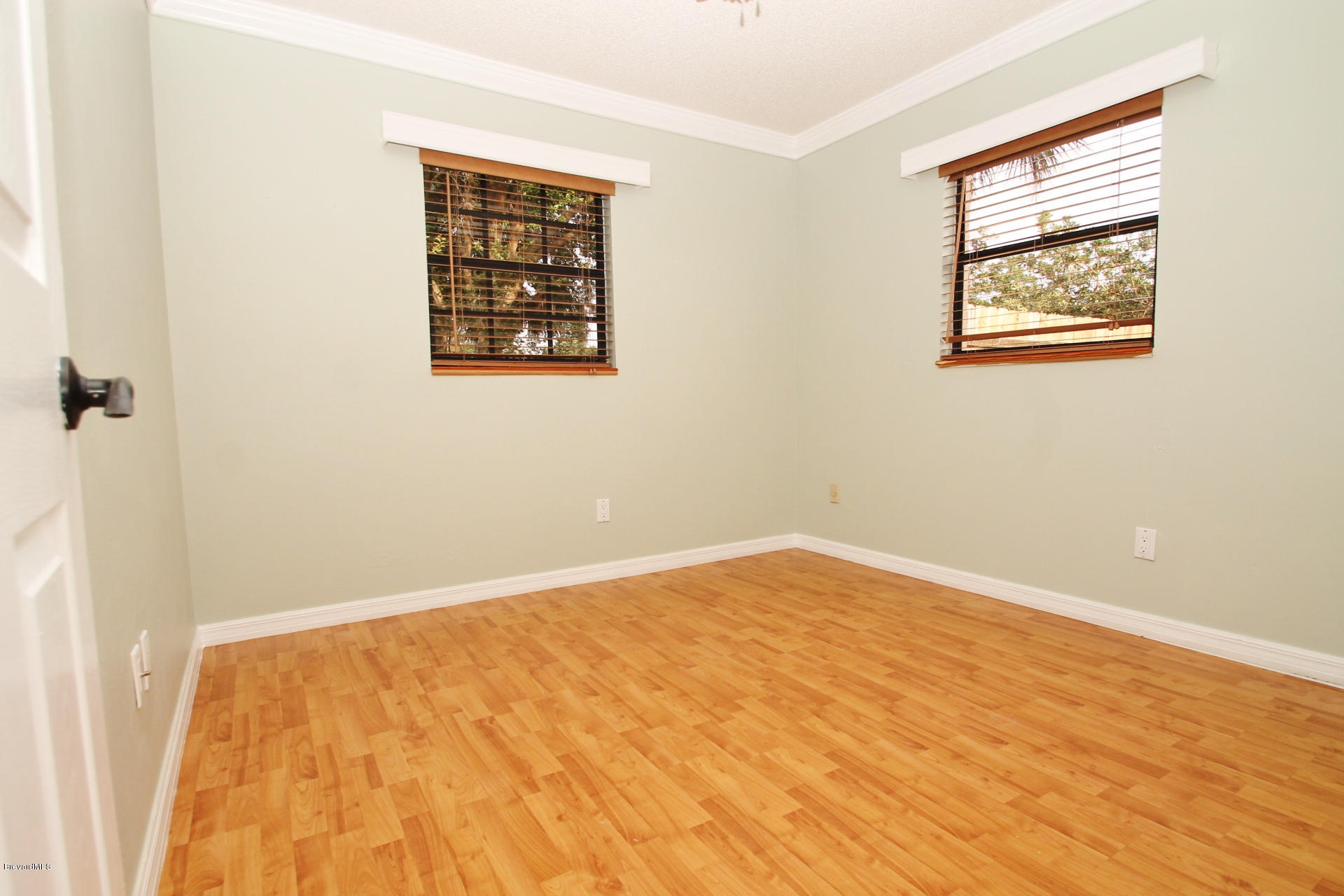 238 Capron Road Port St. John, FL 32927 - Photo 13 of 23 a view of an empty room with wooden floor and a window