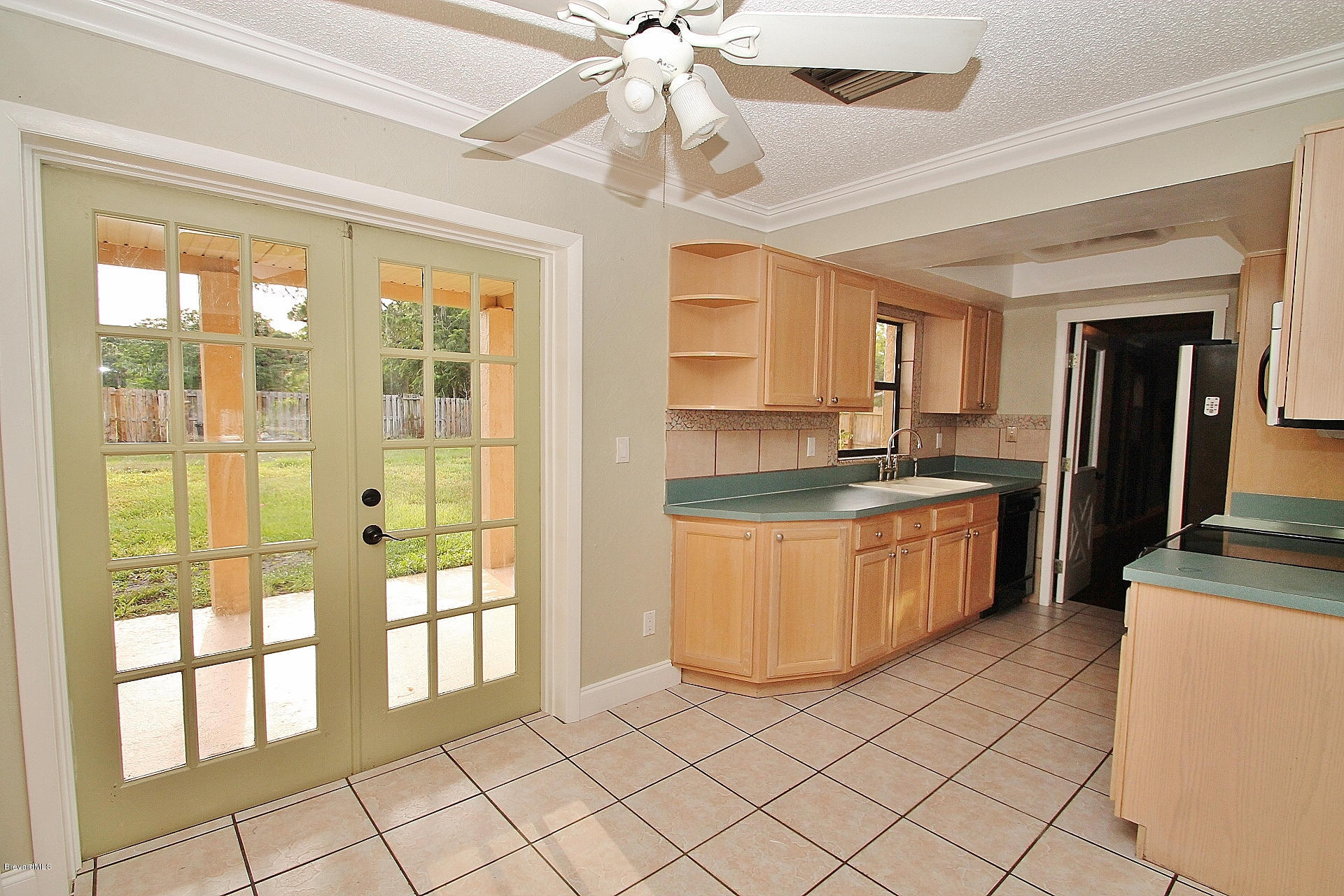 238 Capron Road Port St. John, FL 32927 - Photo 15 of 23 a kitchen with granite countertop a refrigerator a sink a stove top oven and cabinets