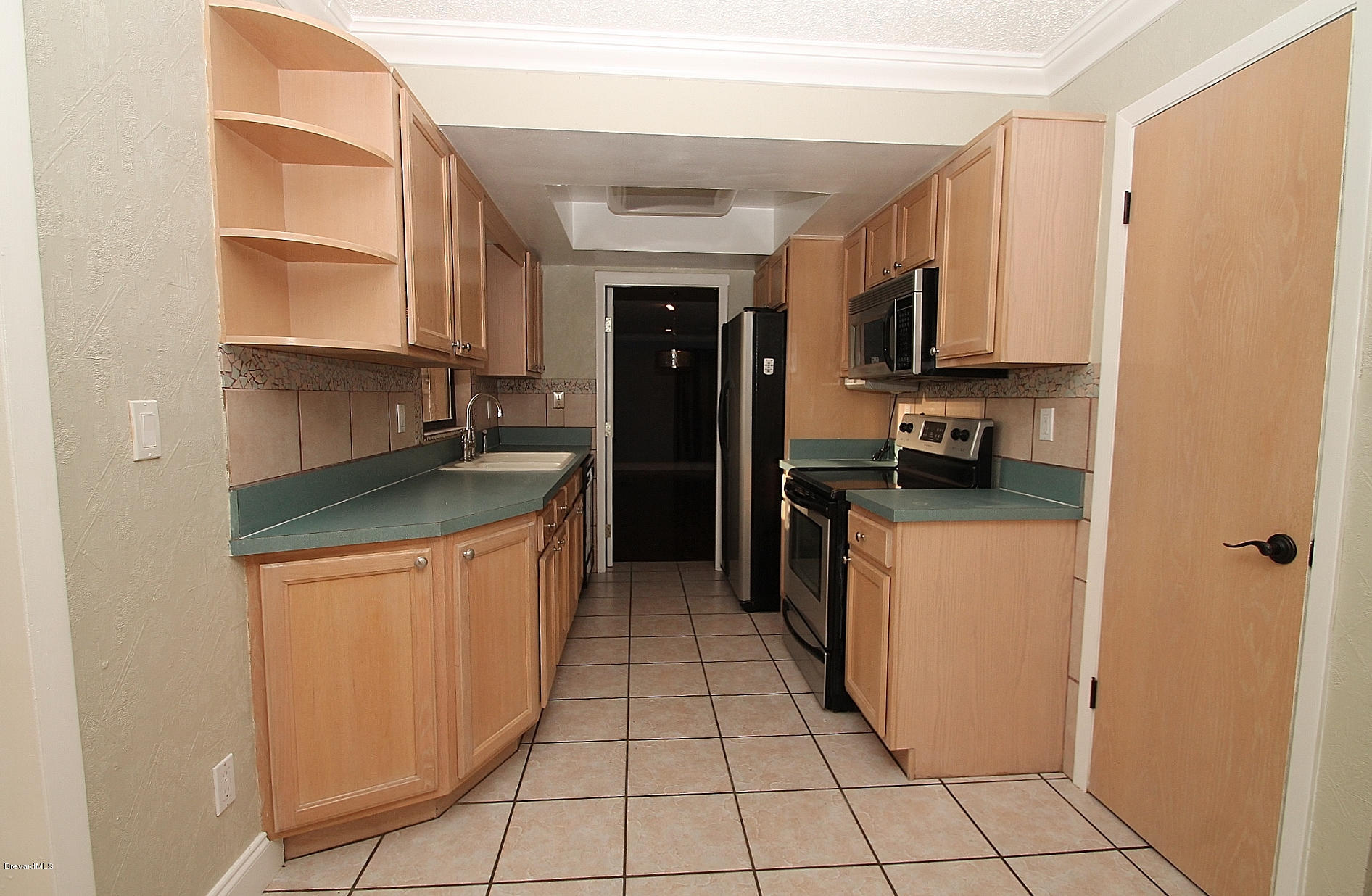 238 Capron Road Port St. John, FL 32927 - Photo 16 of 23 a kitchen with stainless steel appliances granite countertop a refrigerator and a stove