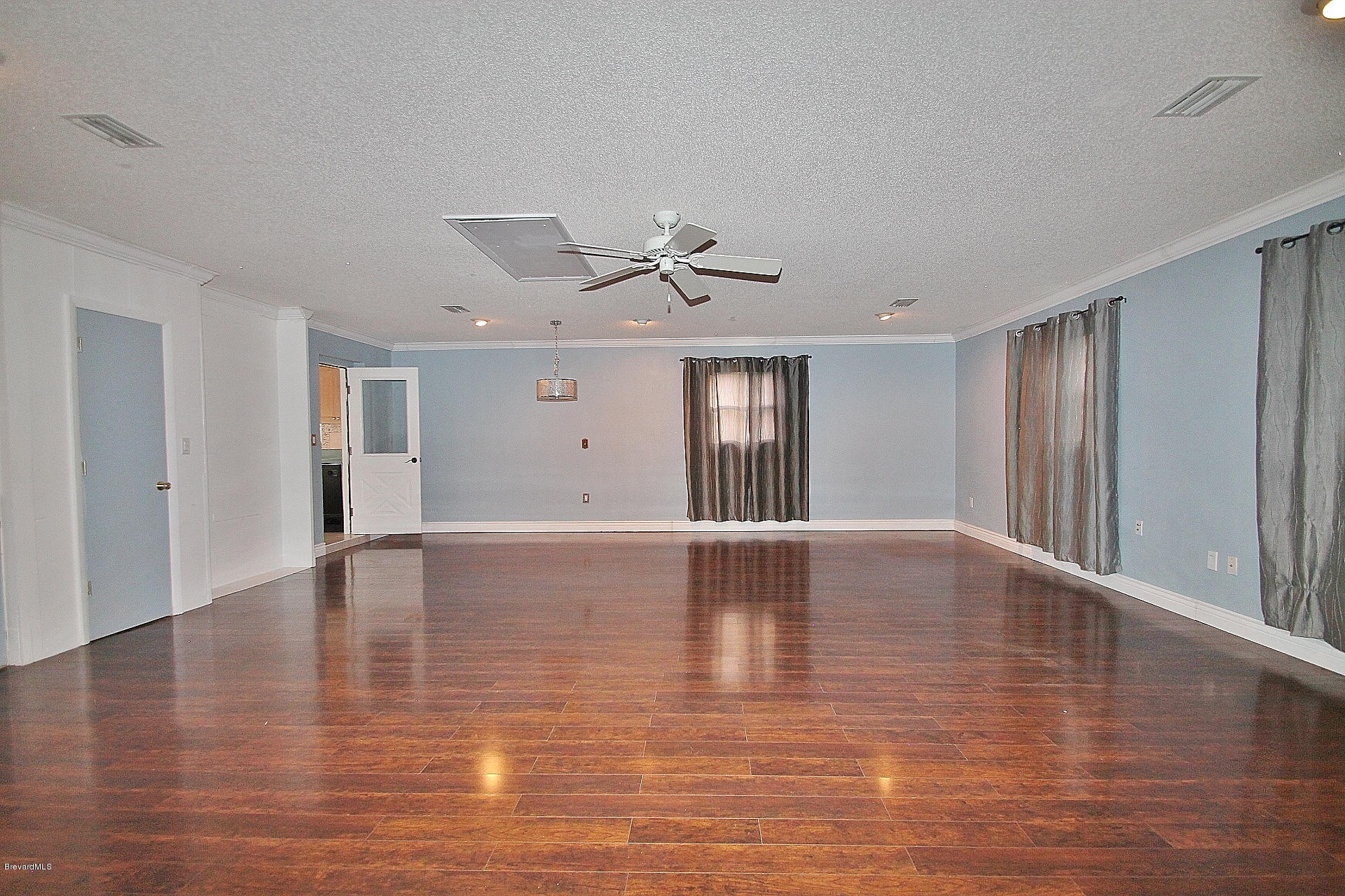 238 Capron Road Port St. John, FL 32927 - Photo 18 of 23 a view of an empty room with window and wooden floor