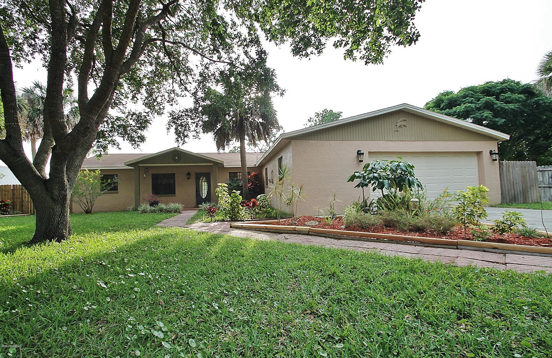 238 Capron Road Port St. John, FL 32927 - Photo 3 of 23 a front view of a house with a yard and garage