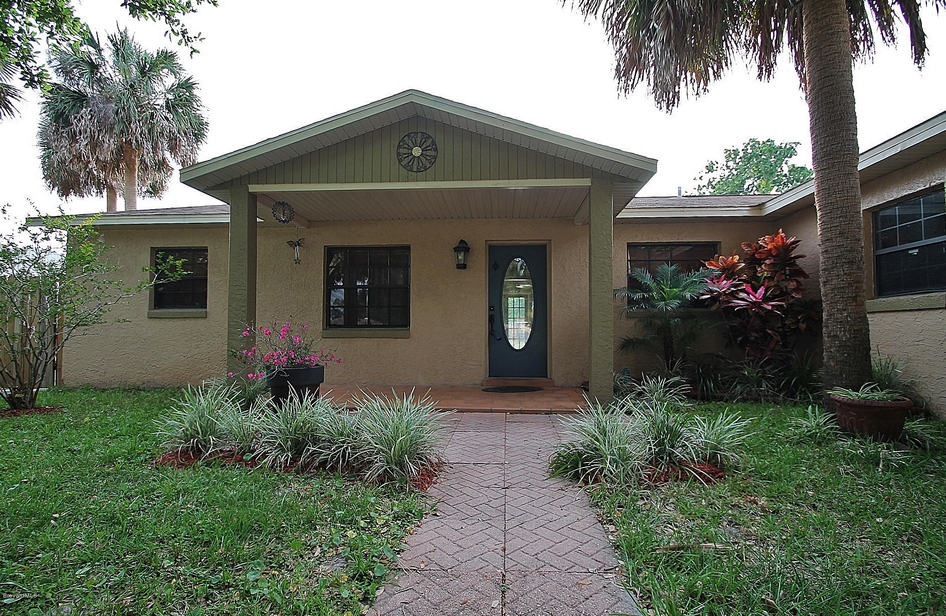 238 Capron Road Port St. John, FL 32927 - Photo 5 of 23 a front view of a house with a garden