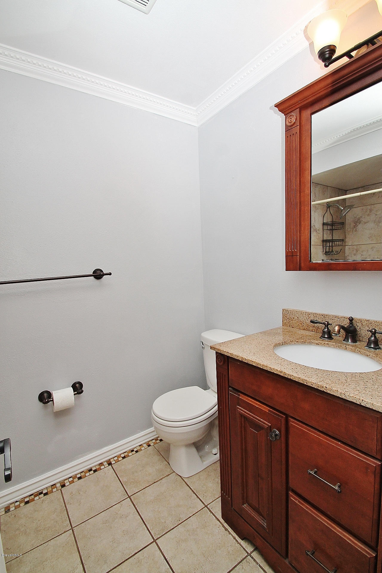 238 Capron Road Port St. John, FL 32927 - Photo 10 of 23 a bathroom with a granite countertop sink a toilet and mirror