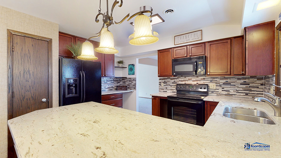 26605 West Wilmot Road Antioch, IL 60002 - Photo 4 of 30 a kitchen with stainless steel appliances kitchen island granite countertop a refrigerator a sink dishwasher a stove with wooden cabinets and floor