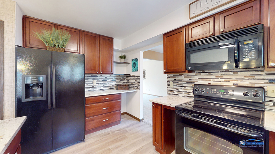 26605 West Wilmot Road Antioch, IL 60002 - Photo 6 of 30 a kitchen with stainless steel appliances kitchen island granite countertop a refrigerator and a stove top oven