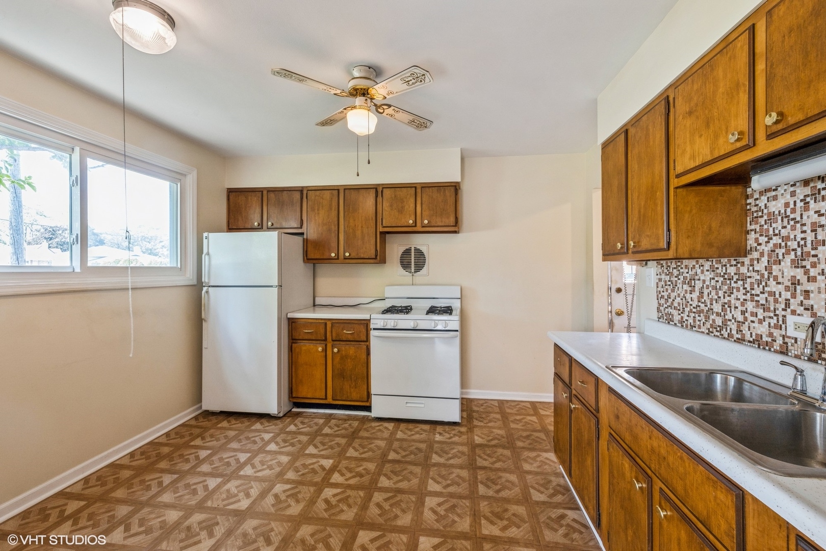 4541 Butterfield Road Hillside, IL 60162 - Photo 4 of 16 a kitchen with a sink a stove cabinets and refrigerator