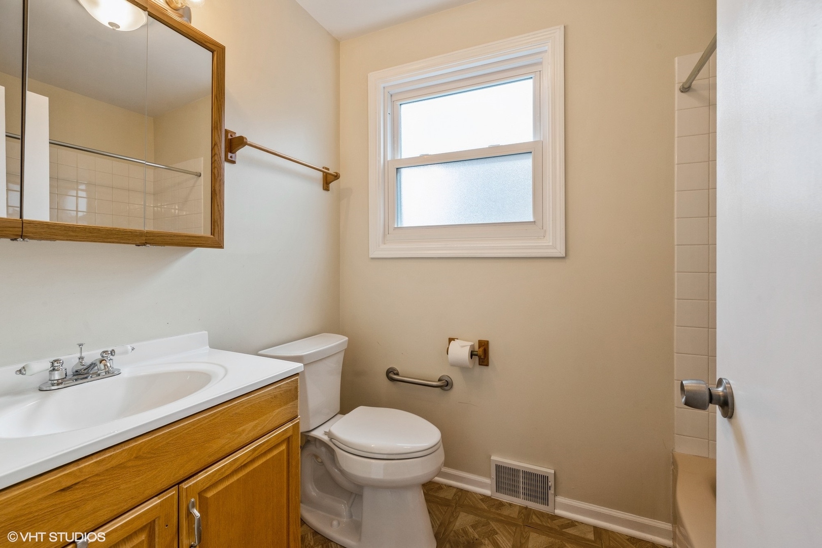 4541 Butterfield Road Hillside, IL 60162 - Photo 6 of 16 a bathroom with a sink a toilet and a mirror