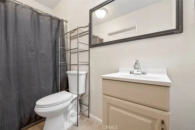 a view of a swimming pool with a yard and palm trees