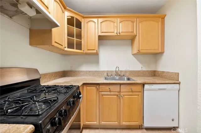 a kitchen with stainless steel appliances granite countertop a stove and a refrigerator