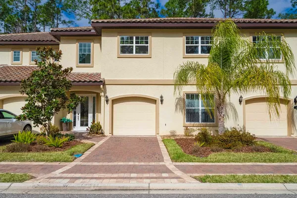 a living room with furniture a flat screen tv and a window