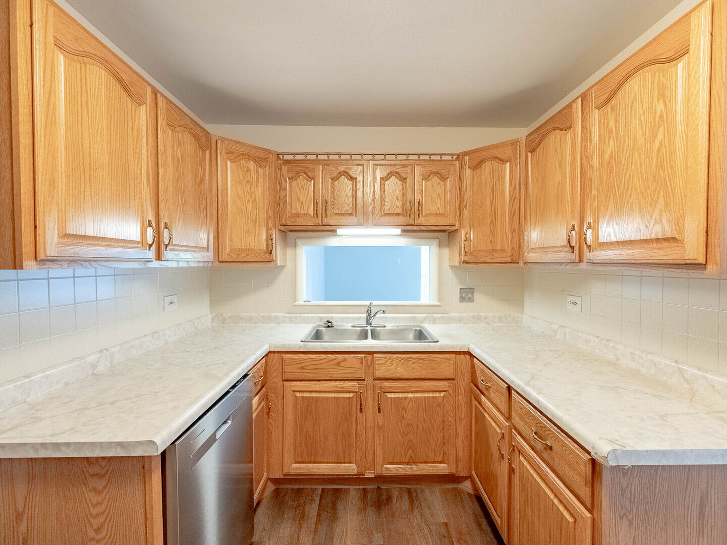 6545 Main Street, Unit 408 Downers Grove, IL 60516 - Photo 6 of 13 a kitchen with a sink a window and cabinets