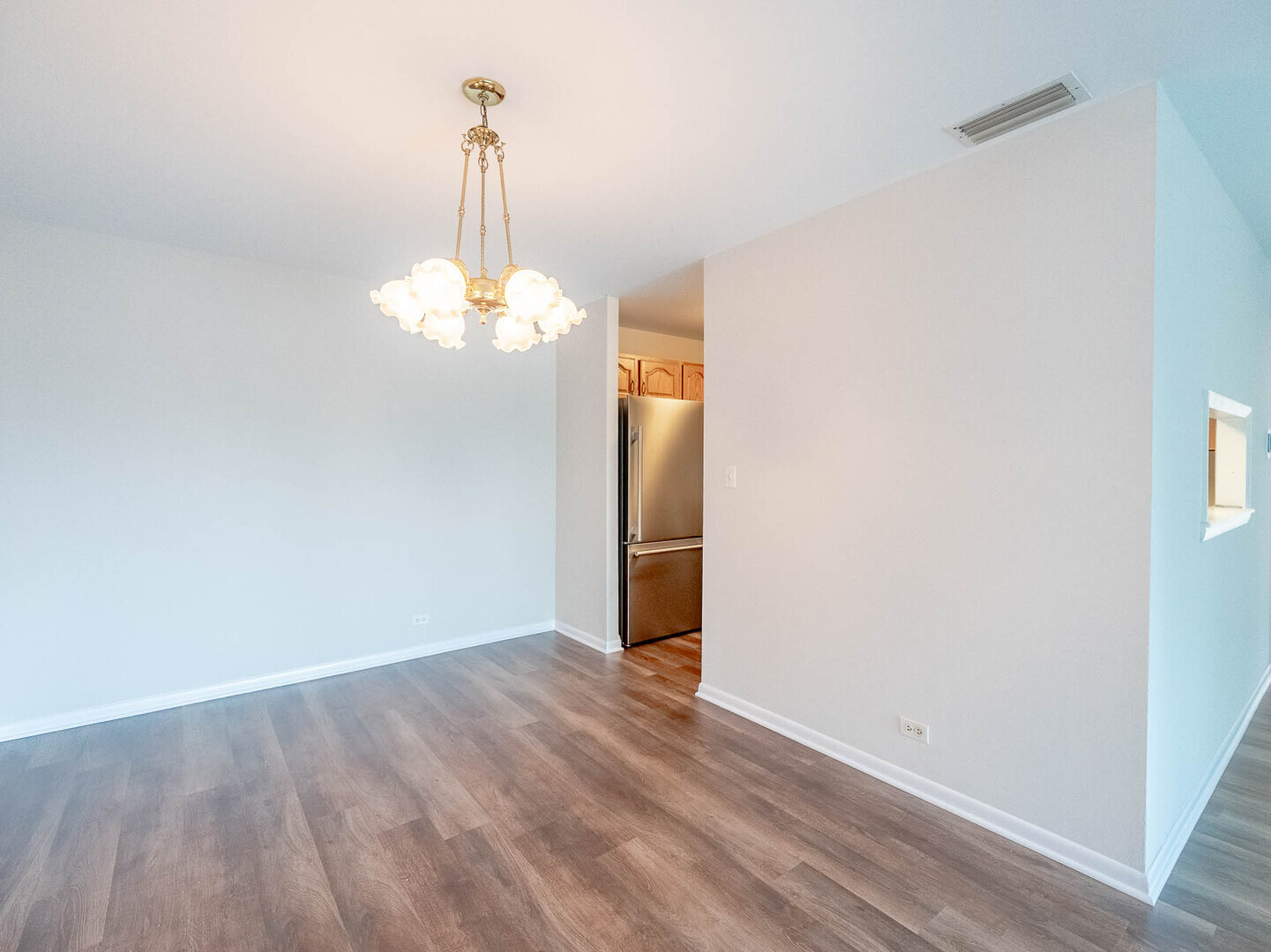 6545 Main Street, Unit 408 Downers Grove, IL 60516 - Photo 8 of 13 a view of a chandelier in hallway view