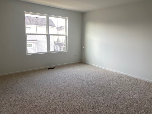 4515 Chelsea Mnr Circle, Unit 4515 Aurora, IL 60504 - Photo 19 of 37 an empty room with a window