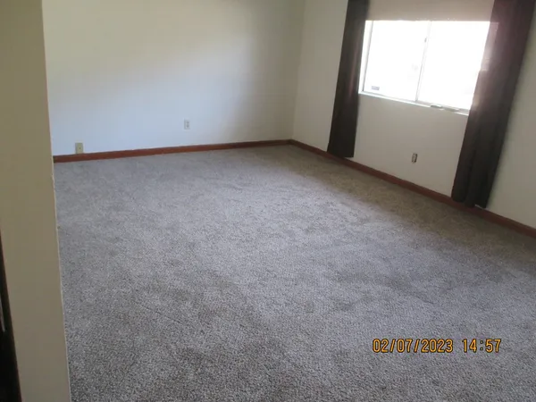 a view of an empty room and a window