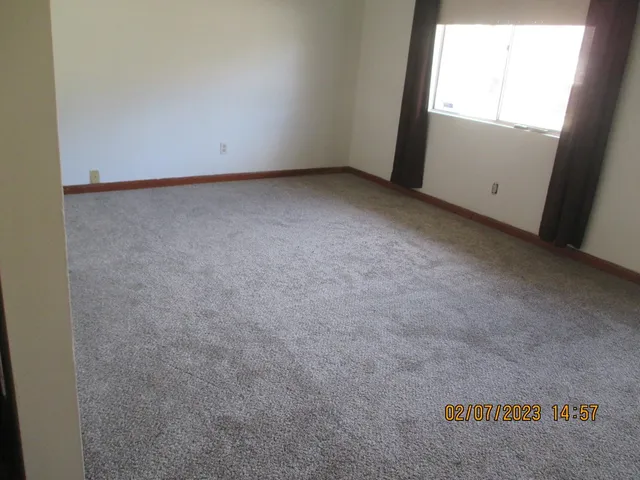 a view of an empty room and a window