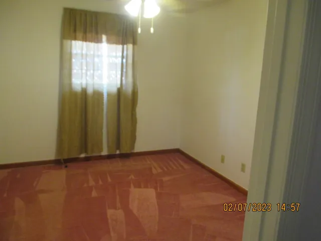 an empty room with windows and closet