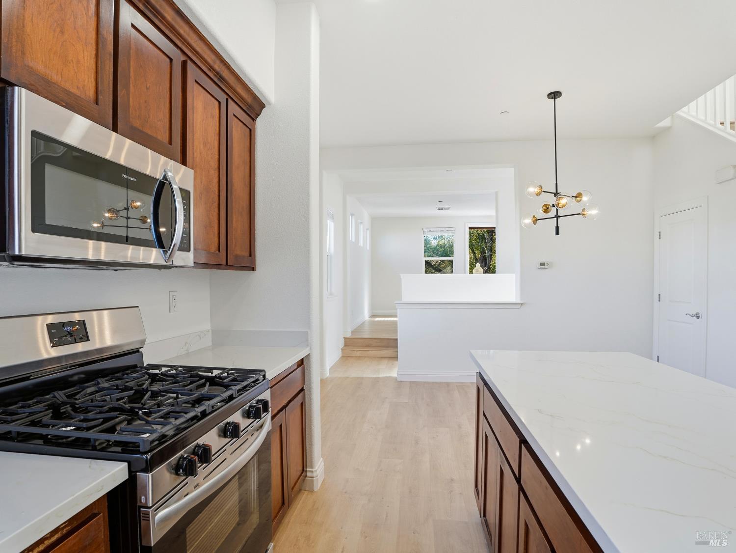 4424 Streamside Drive Santa Rosa, CA 95409 - Photo 15 of 55 a kitchen with stainless steel appliances a stove a microwave and wooden floor