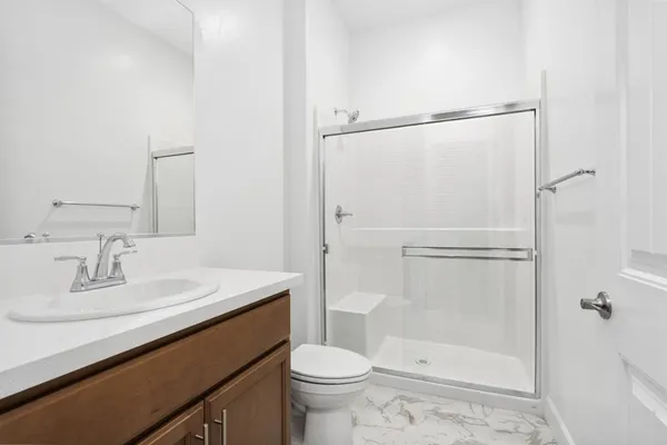 a bathroom with a sink toilet and shower