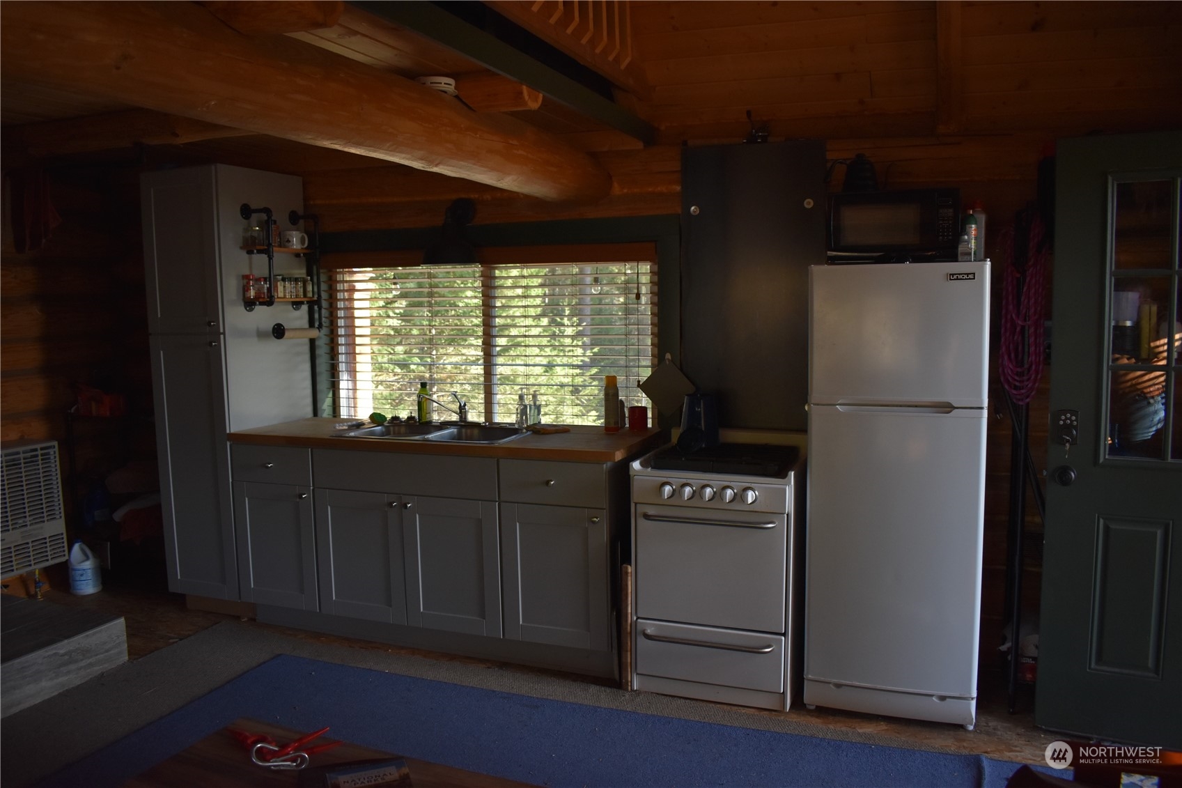 100 Lone Pine Trail Riverside, WA 98849 - Photo 11 of 37 a kitchen with granite countertop a refrigerator a stove a microwave and cabinets