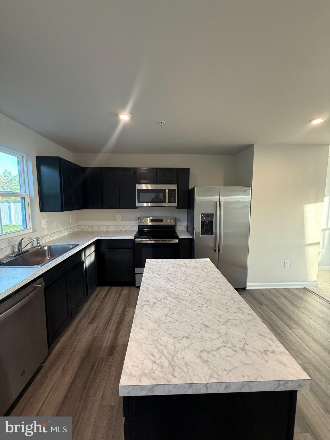 110 Mariners Way Cambridge, MD 21613 - Photo 5 of 22 Sleek modern kitchen with island charm.