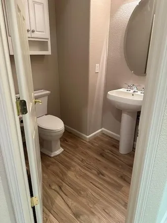 a bathroom with a sink toilet and mirror