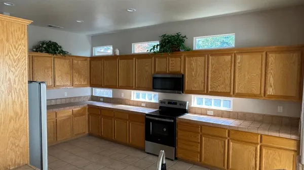a kitchen with a sink cabinets and appliances
