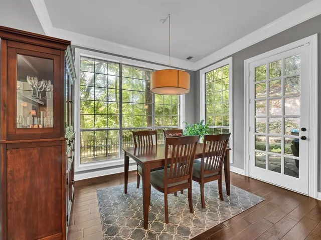 a view of a dining room with furniture large windows and wooden floor