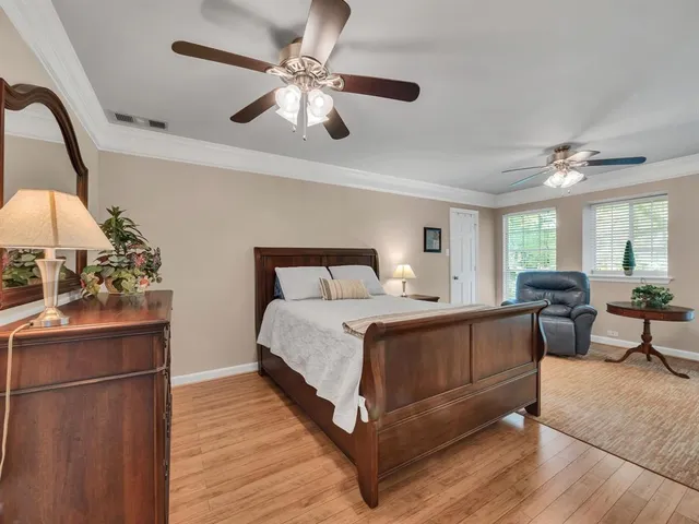 a bed room with a bed and a chandelier