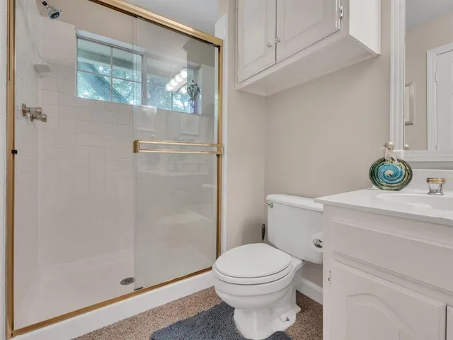 a bathroom with a toilet a sink and shower