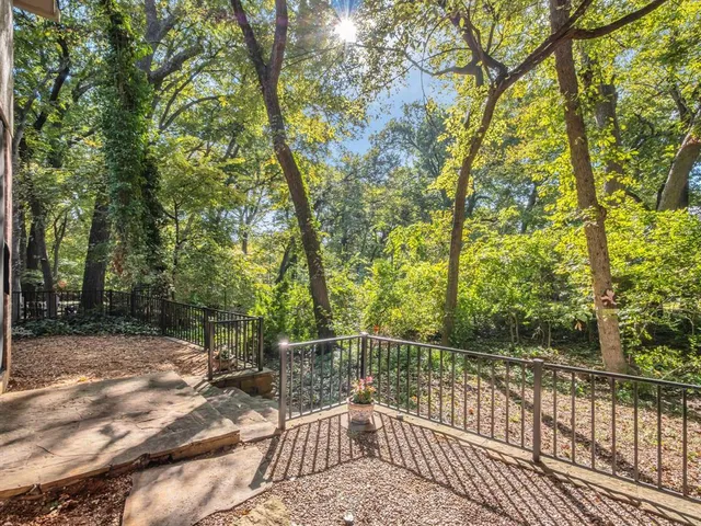 a view of a roof deck with wooden fence and floor