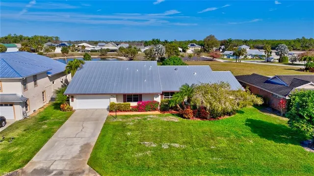 a view of a house with a yard and garden