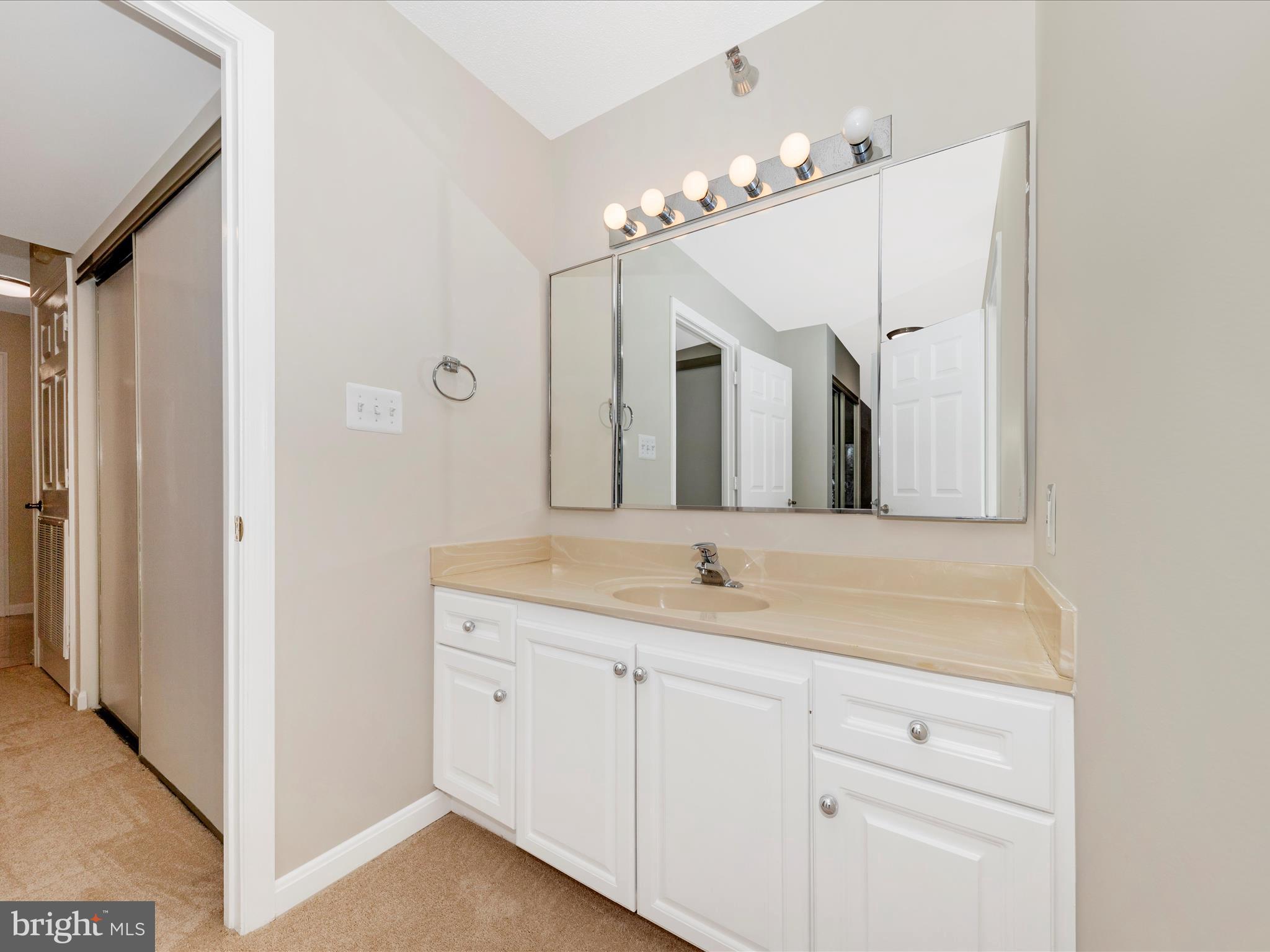 14809 Pennfield Circle, Unit 402 Silver Spring, MD 20906 - Photo 14 of 59 a bathroom with a double vanity sink and mirror