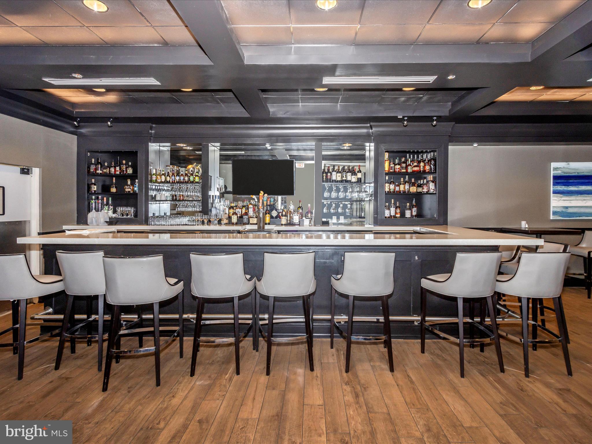 14809 Pennfield Circle, Unit 402 Silver Spring, MD 20906 - Photo 39 of 59 a view of a dining room with furniture and wooden floor