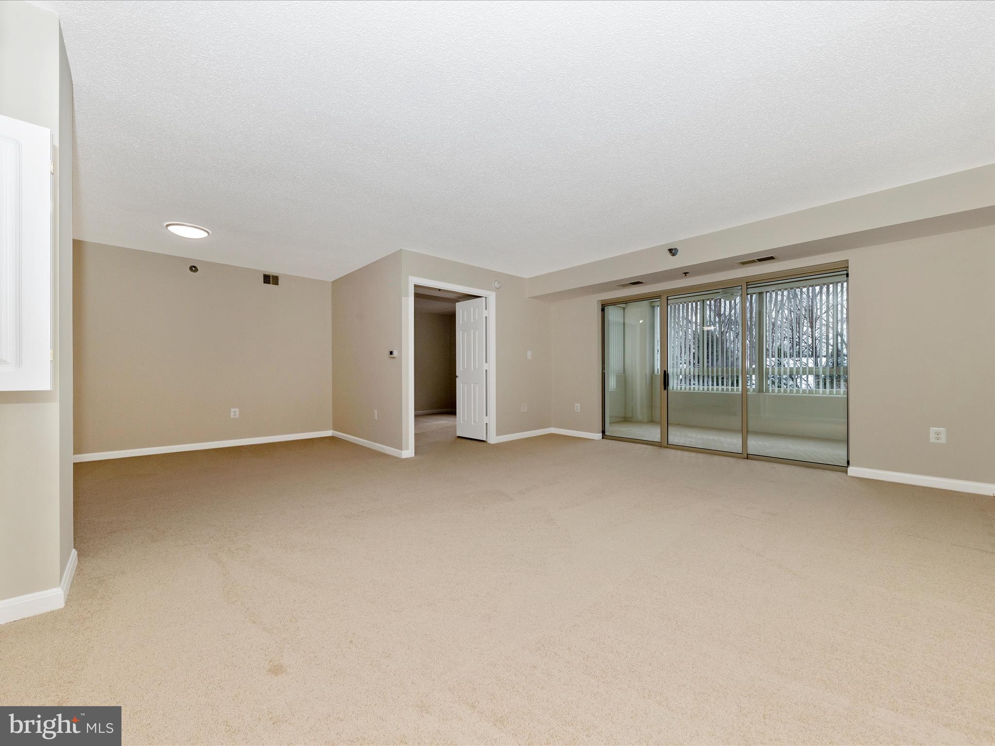 14809 Pennfield Circle, Unit 402 Silver Spring, MD 20906 - Photo 5 of 59 a view of an empty room with glass door