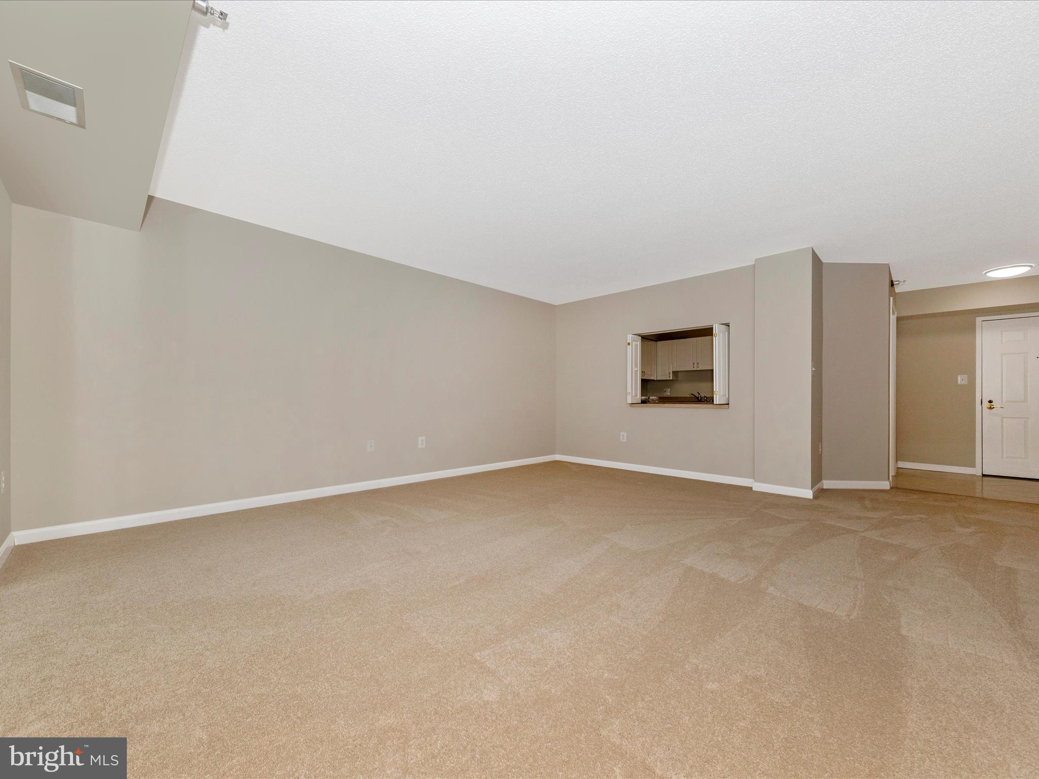 14809 Pennfield Circle, Unit 402 Silver Spring, MD 20906 - Photo 6 of 59 an empty room with a empty space and windows