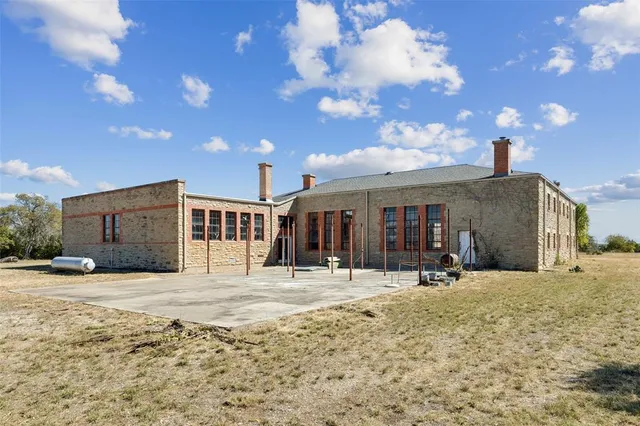a view of a house with yard and sitting area